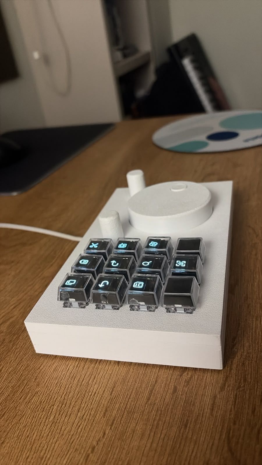 Close-up of the clear keycaps with an OLED icon inside each one and the mechanical switches below.
